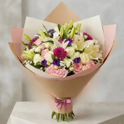 A vibrant dahlia bouquet paired with delicate roses in a luxury seasonal floral arrangement.