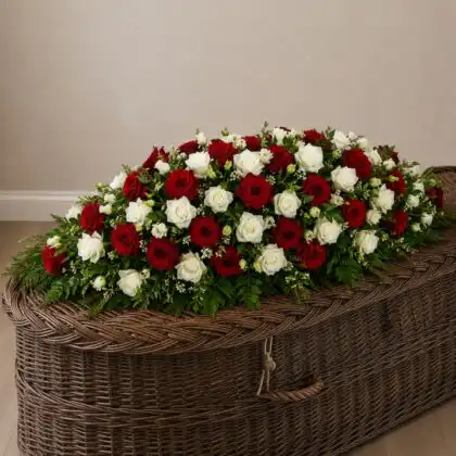 Bold Red and White Rose Coffin Spray on a coffin