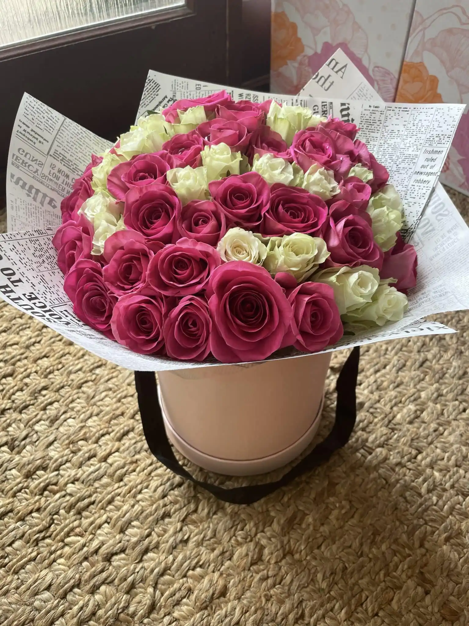 The Luxury Pavilion Pink Rose Hat Box 1 A luxury pink rose hat box featuring a dense arrangement of soft pastel roses in a stylish round container.