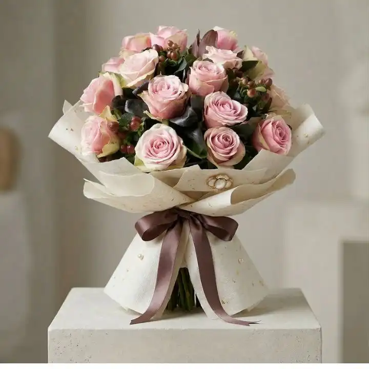 Pink Rose Bliss Bouquet 1 Hand-tied pink rose bridal bouquet featuring dusty pink roses and hypericum berries with green salal leaves.