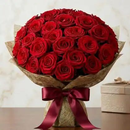 Hand-tied red rose bouquet featuring lush crimson petals and green foliage for a classic wedding ceremony.