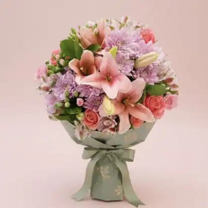 Wishlist 7 A hand-tied chrysanthemum and lily bouquet featuring vibrant pink petals and fresh white blossoms in a decorative wrap.