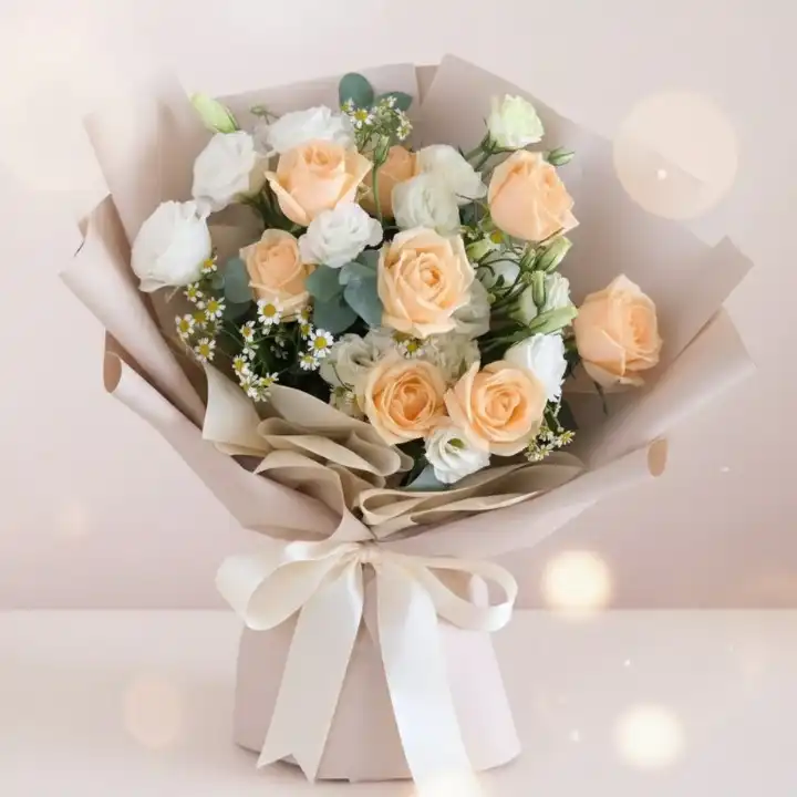 Graceful Peach & Ivory Rose Luxe Bouquet 1 A stunning pink and white rose bridal bouquet accented with fresh green leaves for a classic wedding ceremony.