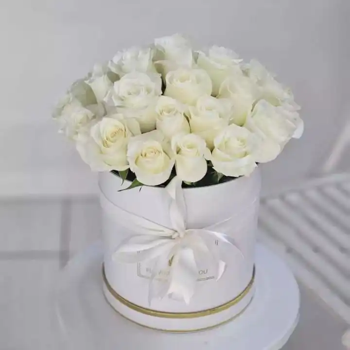 The Luxe White Dome Bouquet 1 A luxury dome shaped bouquet roses white arranged in a minimalist white hatbox with a silk ribbon.
