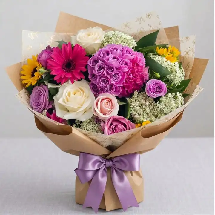 Hand-Tied Sunflower and Rose Bouquet 1 A vibrant hand-tied sunflower and rose bouquet featuring bright yellow petals and deep red blossoms.