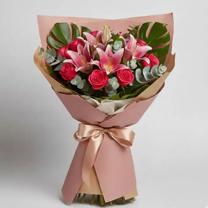 Pink Rose & Oriental Lily Bouquet 1 A luxury Pink Rose & Oriental Lily Bouquet wrapped in premium paper with monstera leaves and eucalyptus.