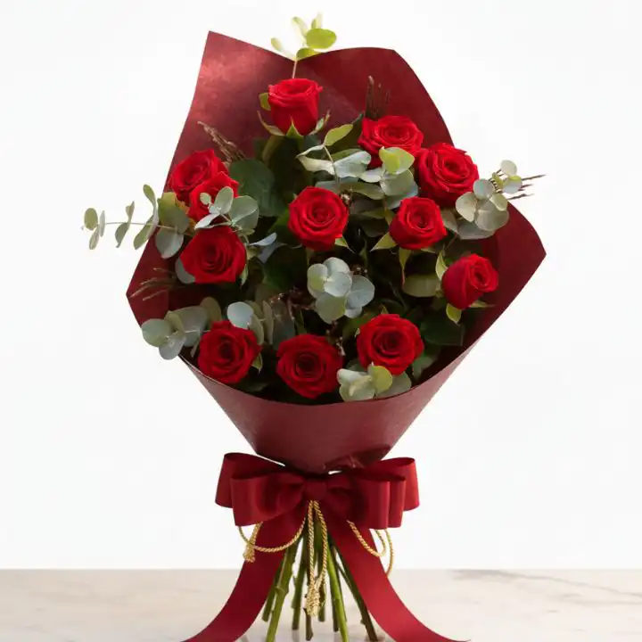 The Scarlet & Sage Bouquet 1 A luxury red rose bouquet with eucalyptus leaves wrapped in premium brown craft paper for a wedding.