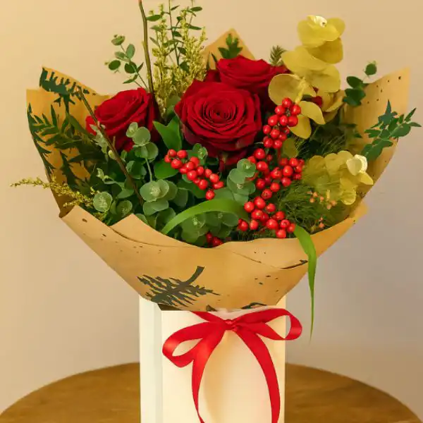 Christmas rose delivery 1 Close-up of a vibrant red Christmas rose arrangement ready for same-day delivery