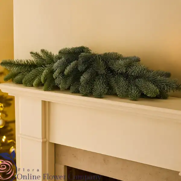 Scented Christmas garland 1 Premium 9-foot scented Christmas garland featuring pinecones, red velvet ribbons, and realistic juniper berries, perfect for stairs or mantel.