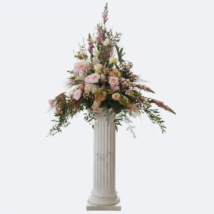 Classic Pedestal Flower Arrangement 1 A large and elegant pedestal flower arrangement featuring soft pink roses and lush greenery on a white marble column.